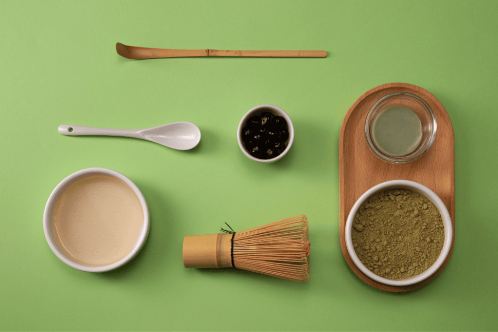 Matcha Kits-wcvendors - WC Vendors Matcha tea kit with whisk, powder, and traditional utensils on green background